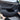 Black door kick protector being placed on the car door lower opening for protection