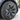 Black wheel cover with textured carbon-fiber look spokes, installed on vehicle wheel