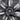 Black Gemini wheel cover close-up, carbon-fiber style stripe spokes