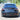 Rear bumper lip diffuser with red LED brake light on a dark sedan