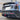 Rear bumper lip diffuser with red LED brake light on a black car