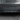 Rear bumper diffuser with carbon-fiber textured panel and three fins, dark
