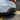 Matte black rear diffuser corner with vented fin insert near wheel