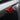 Close-up view of red glossy Carbon Fiber Turn Signal Stalk Covers  intalled on Tesla Model Y Juniper 