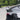 Rear trunk spoiler wing installed on the car’s rear deck, glossy dark black