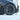 Black multi-spoke wheel cover with center cap and visible tire sidewall
