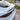 Black carbon fiber rear spoiler on a white car hatch, side detail view.