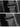 Matte carbon fiber seat belt cover with black trim, close-up on seat interior