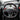 Carbon fiber sport steering wheel close-up, black perforated rim with carbon center spokes.
