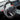 Carbon fiber sport steering wheel with black perforated grips and carbon fiber spoke trim.