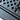 Close-up of textured tabletop surface and hinge/cross-brace connection point