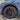 Nylon wheel rim protector with red border around a dark alloy wheel.