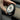 Tesla wireless charging phone mount, circular copper-ring pad held near car console
