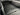 Pickup truck bed cargo net covering ribbed metal floor