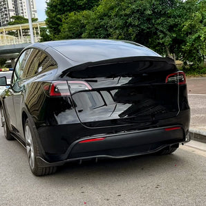 Carbon-fiber rear diffuser on black rear bumper, sporty aftermarket styling