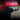 Matte black rear diffuser with side fins on dark red Model Y