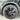 Wheel cover on tire, dark multi-spoke rim with silver outer ring