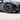 Matte black wheel cover on car wheel, multi-spoke design with tire