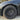 Matte black wheel cover with 10-split spokes and center hub on tire