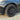 Black wheel cover with multi-spoke pattern and center hub on tire