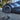 Dark wheel hubcap with aero spoke design and circular center cap on car wheel