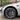 Black wheel cover with aero spoke pattern and circular center cap on car wheel