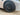 Front wheel close-up: black multi-spoke wheel cover on a car tire
