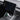 Under-screen storage organizer pull handle near touchscreen, black tray in dashboard