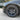 Wheel and tire with multi-spoke alloy rim and circular center cap emblem