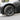 Aero wheel cover installed on a car wheel, dark finish multi-spoke design
