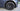Gun grey multi-spoke wheel cover with raised outer trim and center hub