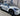 19-inch wheel cover on white car, dark multi-spoke turbine design on rim