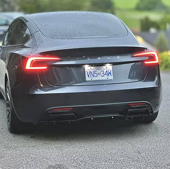 Tesla rear view showing black rear diffuser with finned trim under the bumper