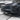 Glossy black front lip spoiler installed on the front bumper edge