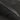 Diagonal close-up of carbon fiber tailgate trim strip with dark weave texture