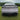 Full-width LED taillight bar on white Tesla rear with red light detail