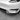 Front lower lip spoiler with black carbon-style texture and aerodynamic fins.