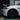 White Tesla Model 3 front corner with yellow LED DRL-style light strip
