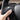 Hand applying carbon fiber steering wheel wrap on a steering wheel control area