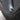 Black aluminum valve stem cap on tire valve stem at wheel rim