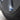 Blue aluminum valve stem cap on tire valve stem at wheel rim